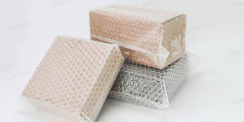 Stacked boxes wrapped in bubble wrap with air filled bubbles, ready for shipping.
