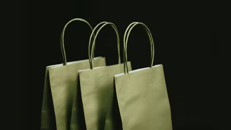 three green paper bags