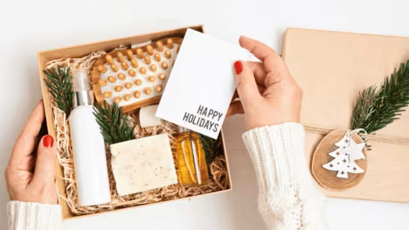 Luxury spa and self-care kit gift box for women, filled with skincare, massage tools, and a festive "Happy Holidays" greeting card.