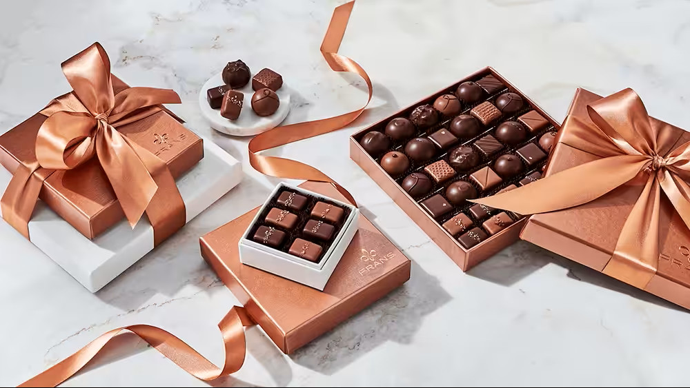 Luxury rose gold gift boxes for women, filled with premium gourmet chocolates, perfect for elegant gifting and special occasions.