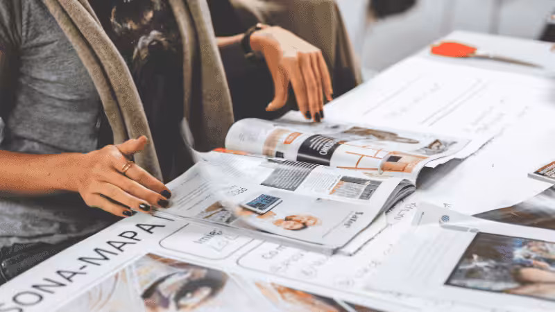 a woman is flipping through magazines