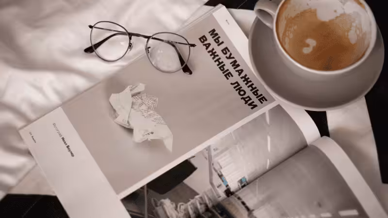 magazine on a table with a cup of coffee