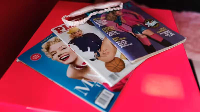 several magazines putting on a pink box