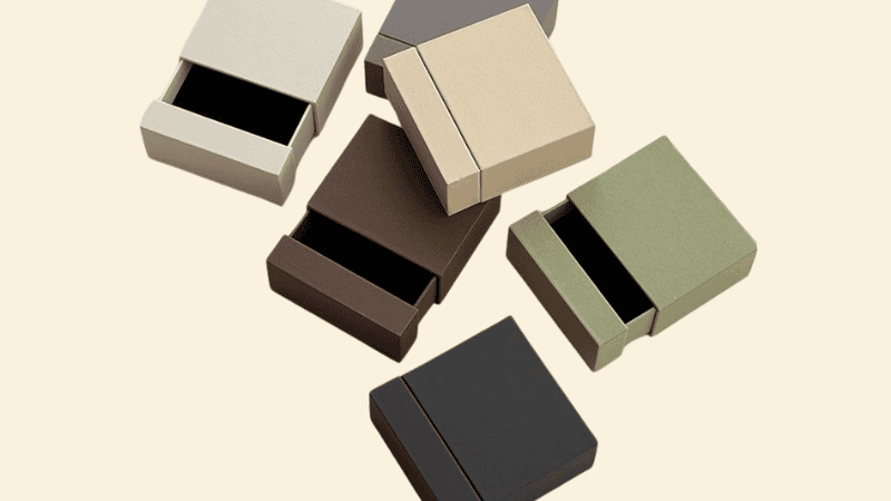 several paper drawer boxes in different colors