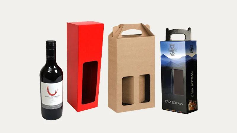 Assorted wine window box packaging: red tall box, kraft double bottle carrier, printed gift box, with wine bottle displayed.