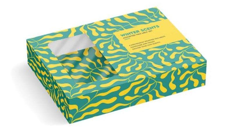 3D mockup of a teal and yellow window box packaging with a wavy pattern, labeled "Winter Scents" for wax melts.