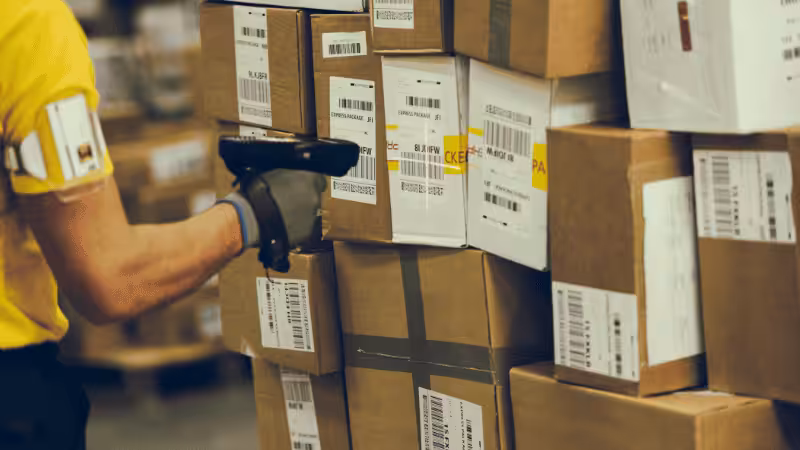 a man is checking the shipping boxes