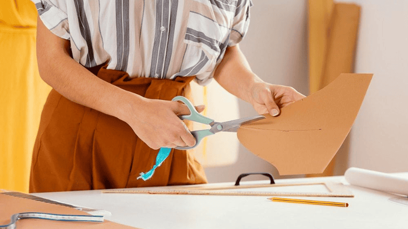 Women cutting cardboard pieces