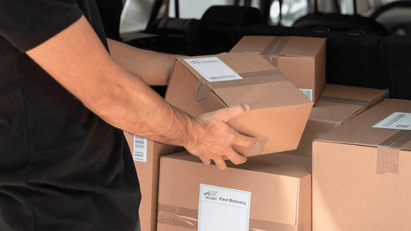 Man loading product boxes into car