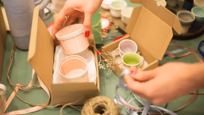 A woman is holding a cup in a box