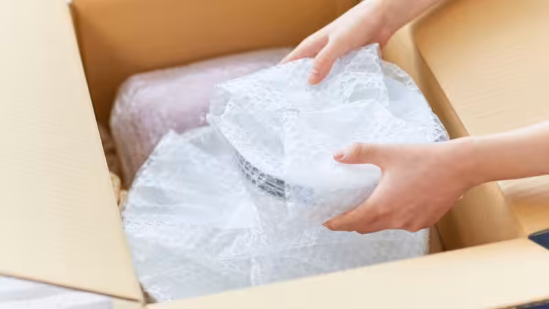 box with some china dished protected by bubble wrap