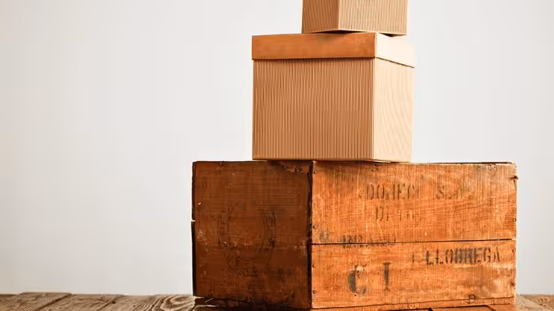 Different-sized cardboard boxes on top of a wooden crate