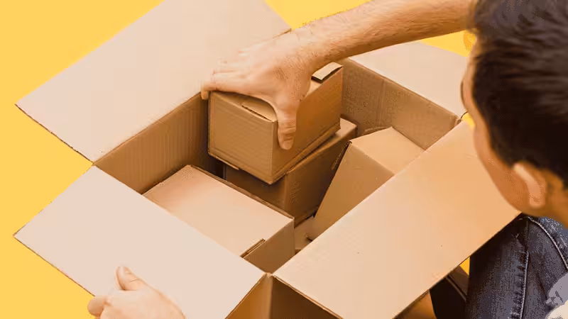 Man consolidating several small packages in one large box