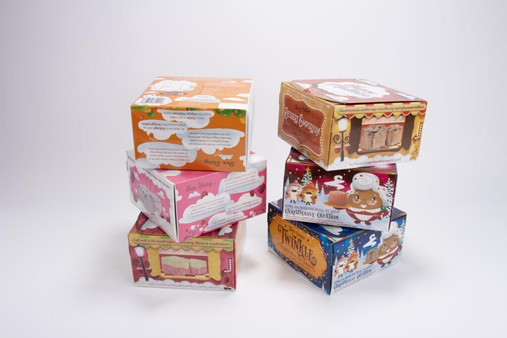 Stacked festive cartoon themed custom blind box packaging boxes with dessert and Christmas print designs
