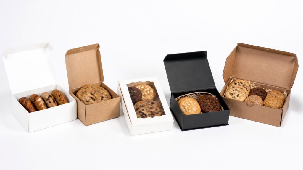 Collection of custom cookie boxes in white, kraft, matte black, window & solid tuck top styles, foldable bakery packaging for assorted gourmet cookies, multi-style cookie packaging options